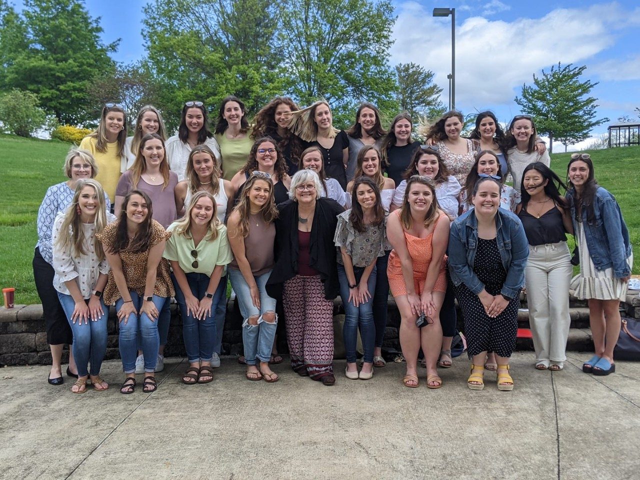 the 2021 class of elementary education master's degree graduates pose with dr. fogelsong and dr. bradley. They are all female, and mostly white. three are asian