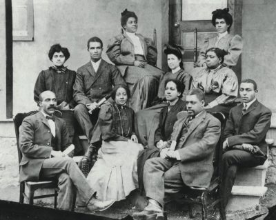 Principals Charles L. Marshall (front row on the left) and Edgar A. Long (front row, second from right) gather with teachers in front of a Christiansburg Institute classroom building.