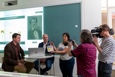 Computer science associate professor Kurt Luther demonstrates his Civil War Photo Sleuth software in an interview with the History Channel in October 2019 at the Virginia Tech Research Center in Arlington, Virginia.