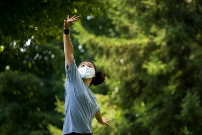 A dancer practices her art while masked