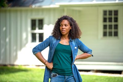 Kerri Moseley-Hobbs, a descendant of the Fraction family, stands in front of the Fraction Family House, which once housed multiple generations of the Fraction, McNorton, and Saunders families, who were enslaved on the Solitude plantation.