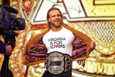 Stephen Woltz shows off a "Virginia Is for Lovers" T-shirt and his new All Elite Wrestling championship belt
