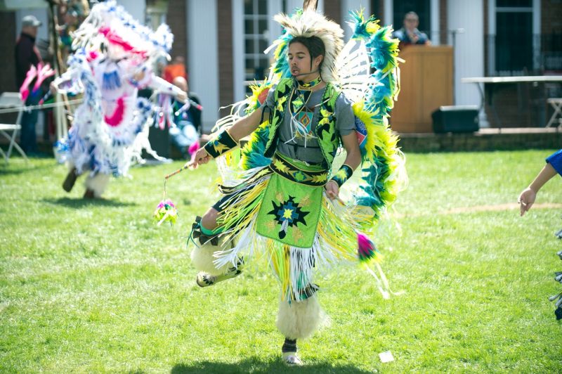 Christian Stewart, a student studying wildlife conservation, wears traditional regalia as he takes part in a previous powwow.