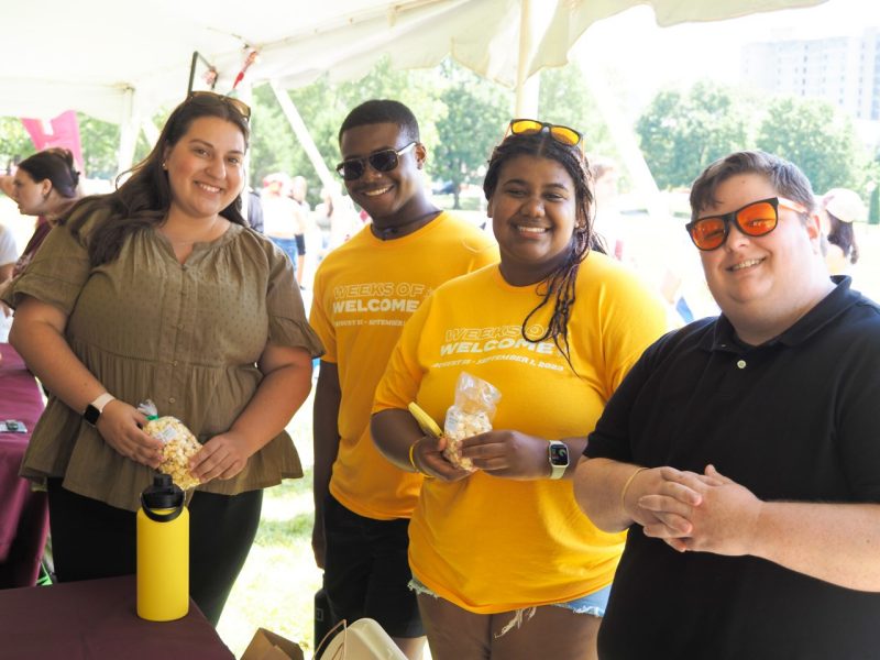 Two students and two staff members smile for a picture during the CLAHS Social event.
