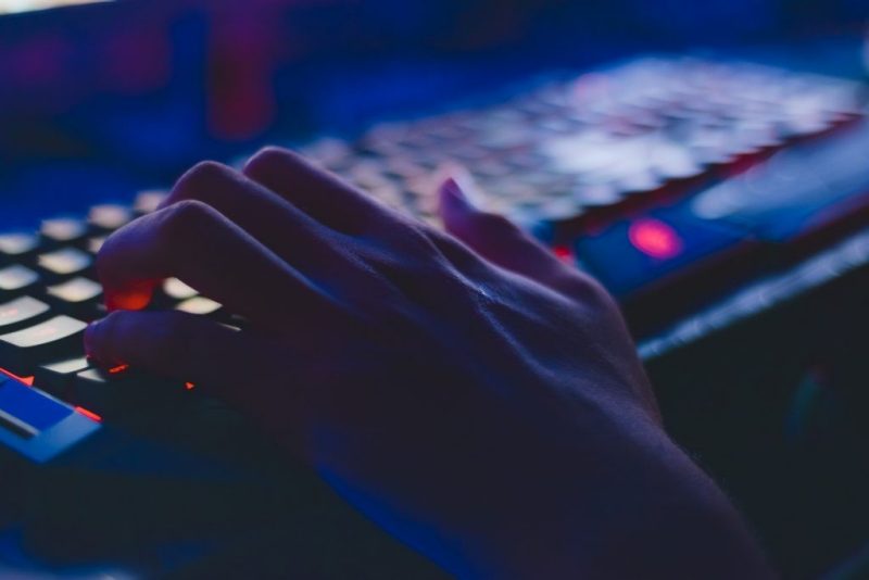 A person's fingers type on a lit up keyboard Photo credit: Pexels