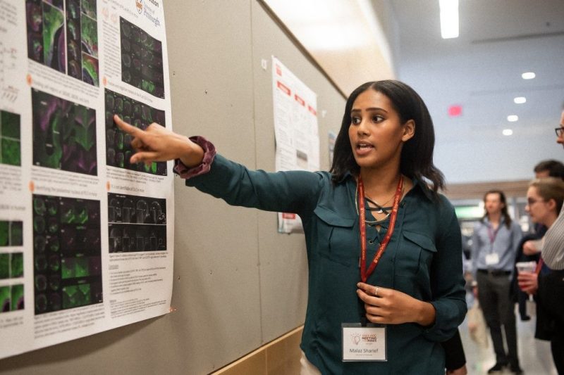 Malaz Sharief, a visiting student from University of Pittsburgh, presents during a poster presentation at the Meeting of the Minds conference. 