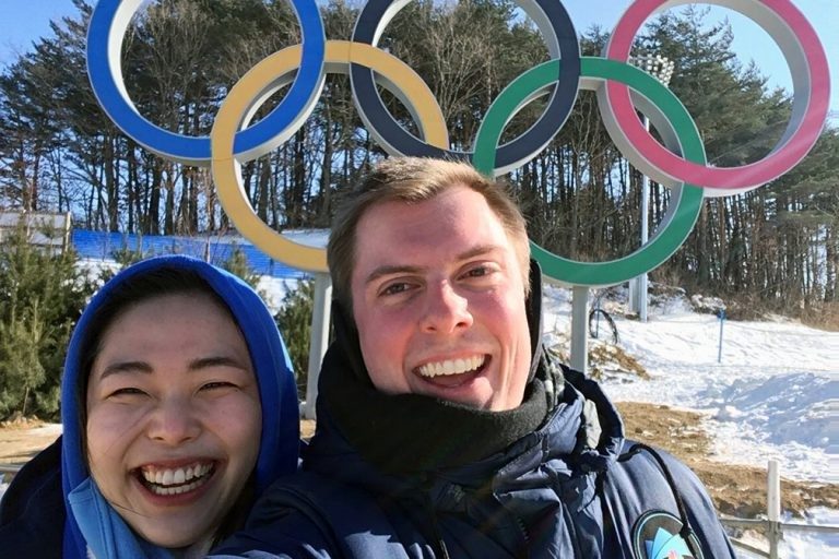 Harvey Creasey takes a selfie with Kayla, one of his Korean translators, in front of the famed Olympics logo.