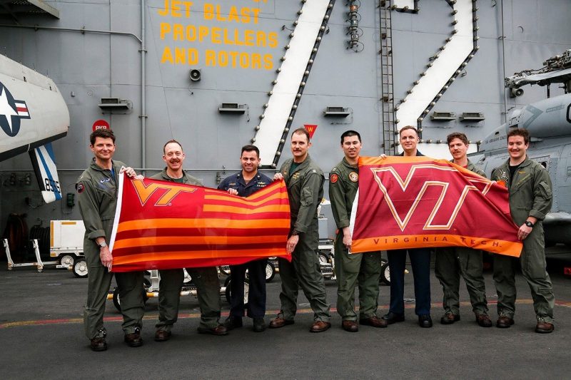 Hokie alumni deployed with the Carrier Strike Group 12 include, from left, Cmdr. Matthew Wright, Cmdr David Dartez, Lt. Cmdr. Anthony LaVopa, Lt. Nick Len, Lt. Tom Clapp, Aerographer's Mate 2nd Class Patrick Nichols, Lt. Joe Haslem, and Lt. Jonathan Bressette. Not pictured are Lt. Mondre Barnes and Lt. Tyler Manuel.