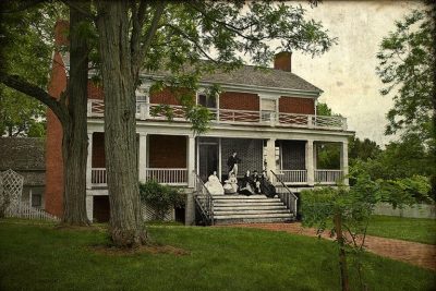 A contemporary shot of the McLean House, the site of General Robert E. Lee's surrender at Appomattox Court House, overlays a photograph of the McLean family sitting on their porch soon after the Civil War ended. (Courtesy of Ron Zanoni)