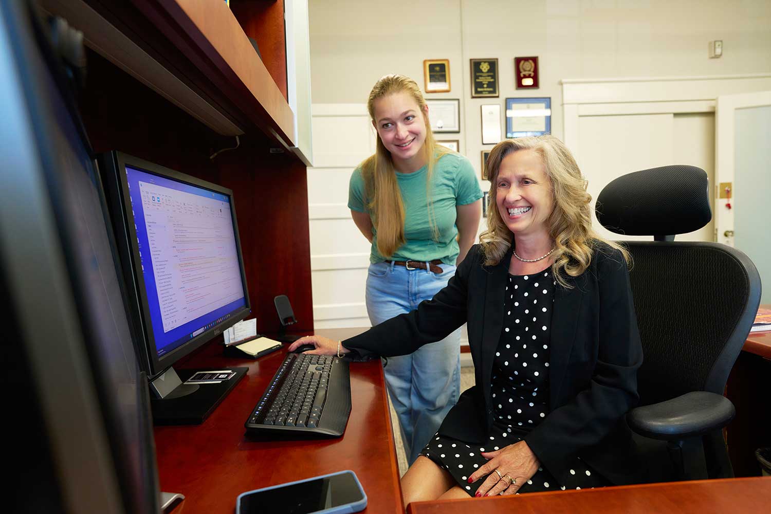 A student looks over the should of a Gerontology staff member during training