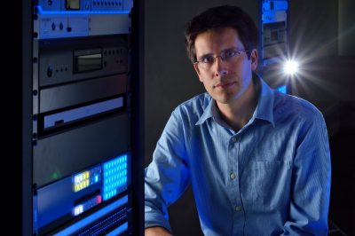 College of Liberal Arts and Human Sciences Outstanding Faculty Mentor Matt Wisnioski next to a computer