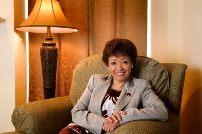 Female professor sitting in chair