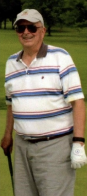 Man in golf attire, smiling.