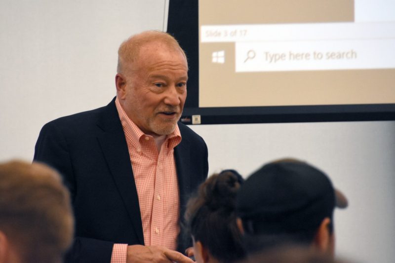 Man in front of classroom talking to students