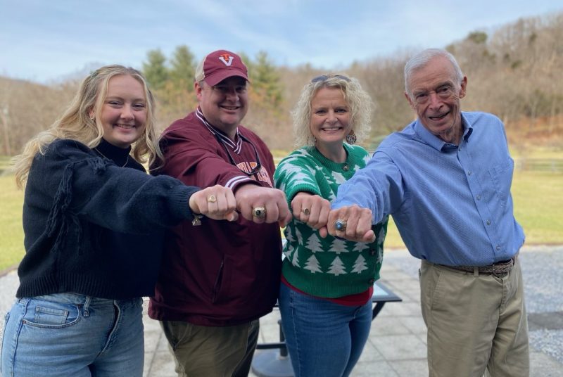 Four people holds their hands out with class rings representing the years they graduated from Virginia Tech.