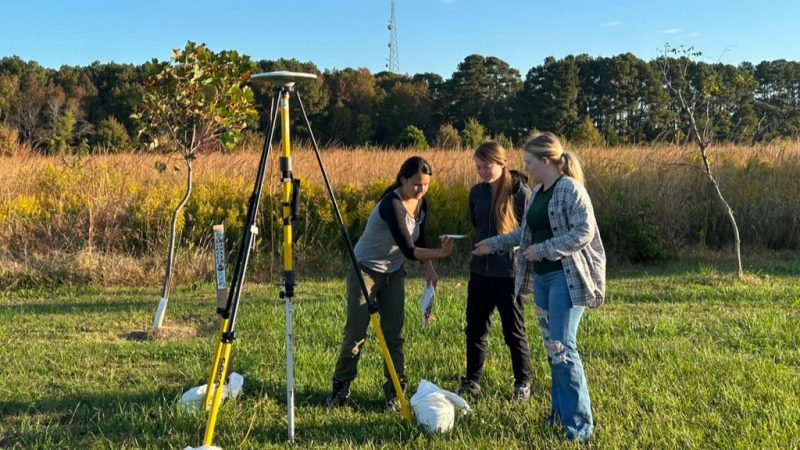 Three students set up antennae