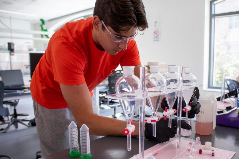 A student taking measurements inside a lab.