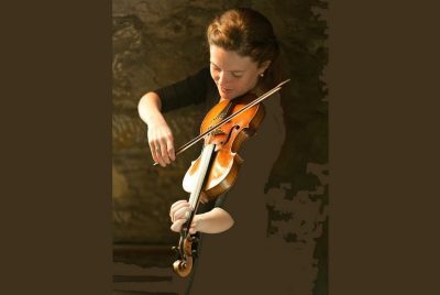 Fiona Hughes, playing a violin