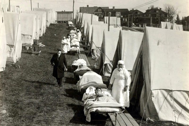 A makeshift outdoor tent hospital in Brookline, Massachusetts, with patients lined up on cots outside the tents