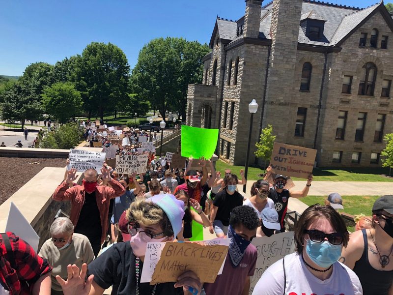 Protesters pass the Virginia Tech College of Liberal Arts and Human Sciences Building in Blacksburg on June 1.