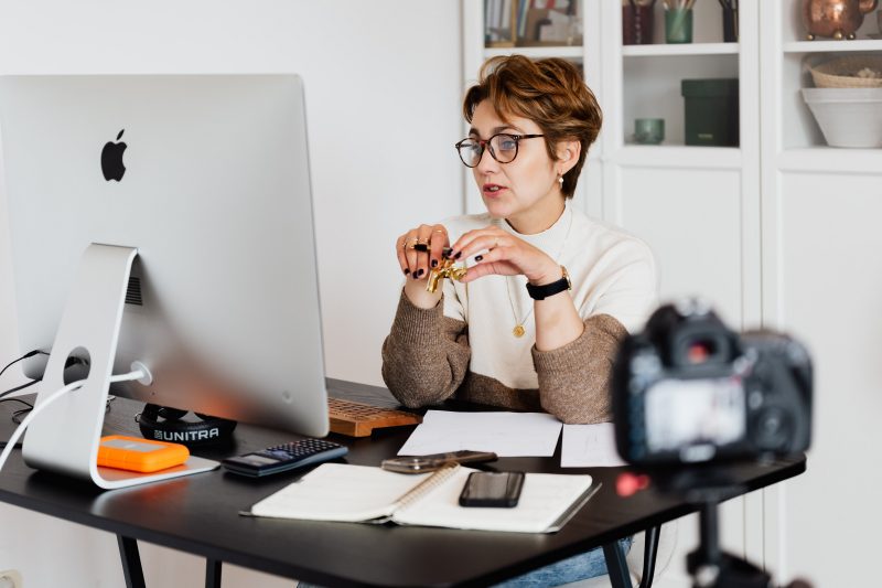 a woman with short hair and glasses participates in an online discussion