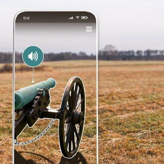 an image of an iphone with the image of a cannon in a field