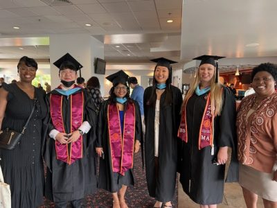 Drs. Taylor and Brand pose with master's science education graduates