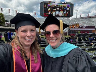 Dr. Jodie Brinkman poses with an educational leadership graduate