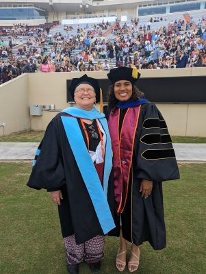 Dr. Donna Fortune poses with a doctoral graduate
