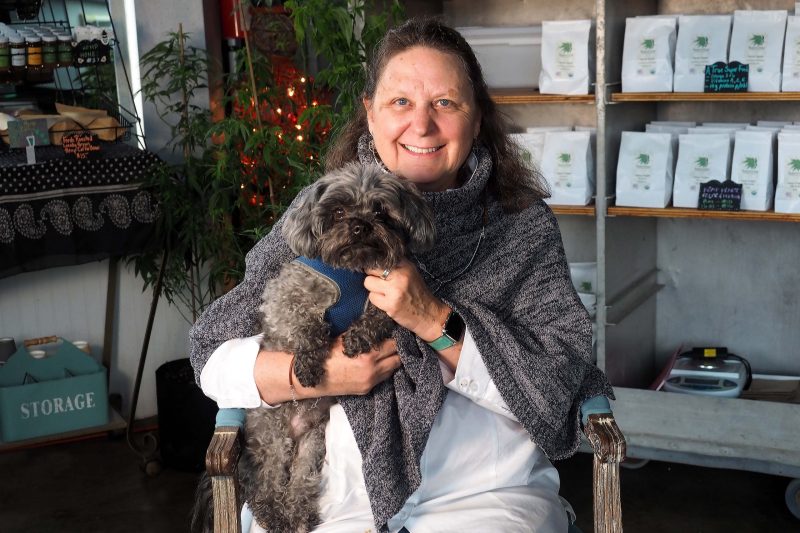 Deborah Custer sits in the Innovation Mill with Oliver, the namesake of a product she created to reduce anxiety in dogs and cats.