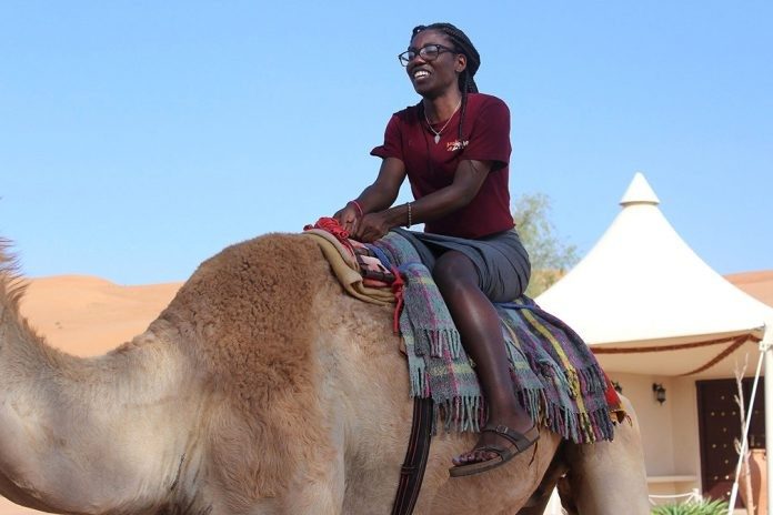 Katherine Louis rides a camel in Oman. Photo courtesy of Katherine Simko