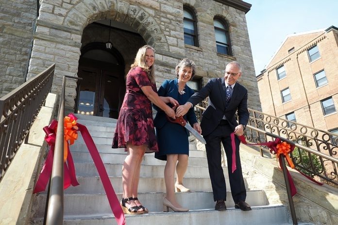 Dean Rosemary Blieszner (center) joined LaTawnya Burleson, president of the college’s Staff Association, and Cyril Clarke, executive vice president and provost of Virginia Tech, in the official ribbon cutting for the college’s new headquarters.