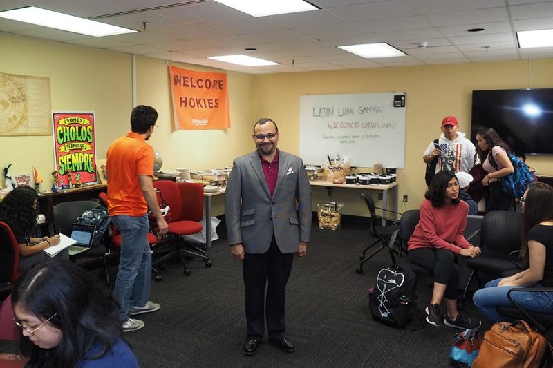 Carlos Evia, co-chair of the Latinx Symposium, stands amid the swirl of El Centro, Virginia Tech’s Hispanic and Latinx Cultural Center, during a luncheon for students.