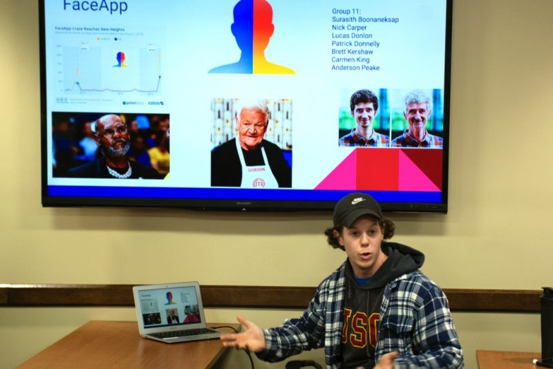 Political science senior Brett Kershaw presents research on smartphone apps that gather personal data during a research presentation for an Introduction to Data in Social Context class. 
