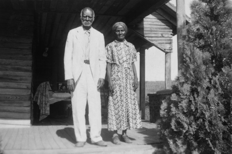 Anderson and Minerva Edwards stand together on a front porch