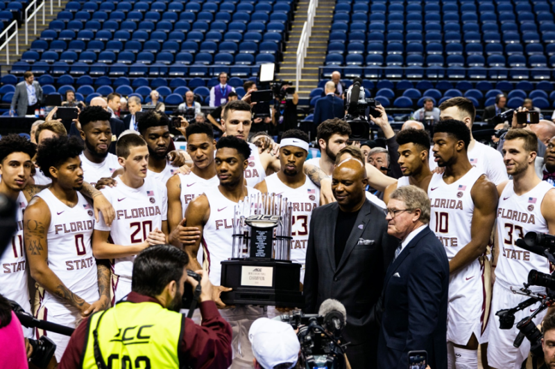 Members of the Florida State team have muted responses while accepting the trophy during the ACC Men’s Basketball Tournament. The team had just been designated the winner without playing a single game after the conference elected to cancel the tournament because of the COVID-19 pandemic. Photo by Liam Sment.