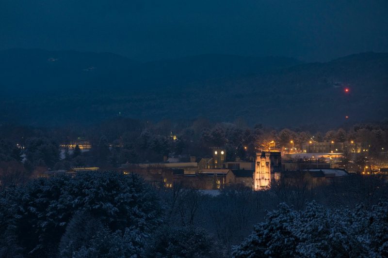 Burruss Hall and the rest of campus is seen with the Appalachian Mountains in the background during twilight following a day of snow. 