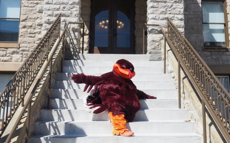 HokieBird on the steps of the College of Liberal Arts and Human Sciences Building.