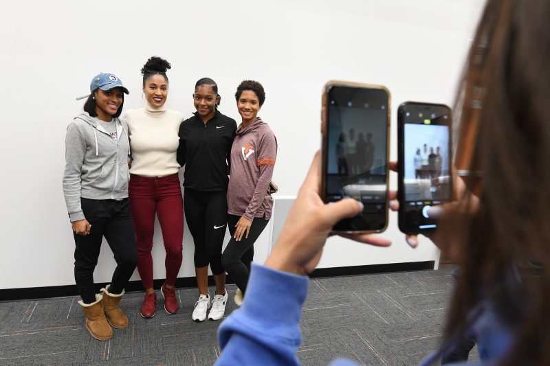 Queen Harrison posing with members of the VT women's track and field team
