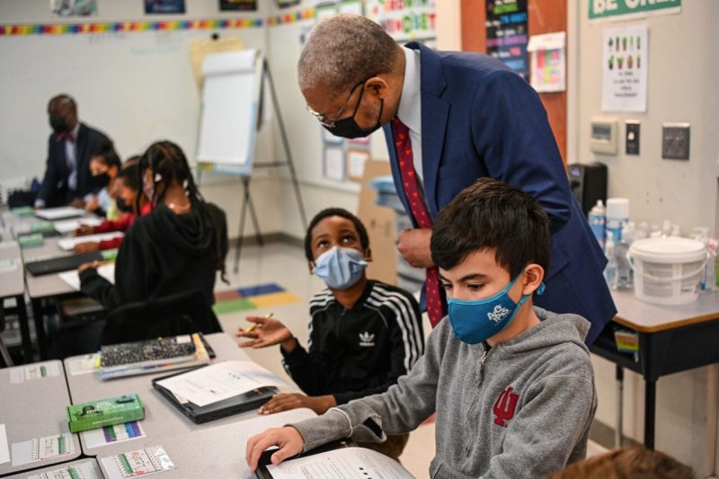 Lance Collins, Virginia Tech's Innovation Campus vice president and executive director, participates with students at James K. Polk Elementary School as teachers begin lessons that incorporate micro:bit technology.