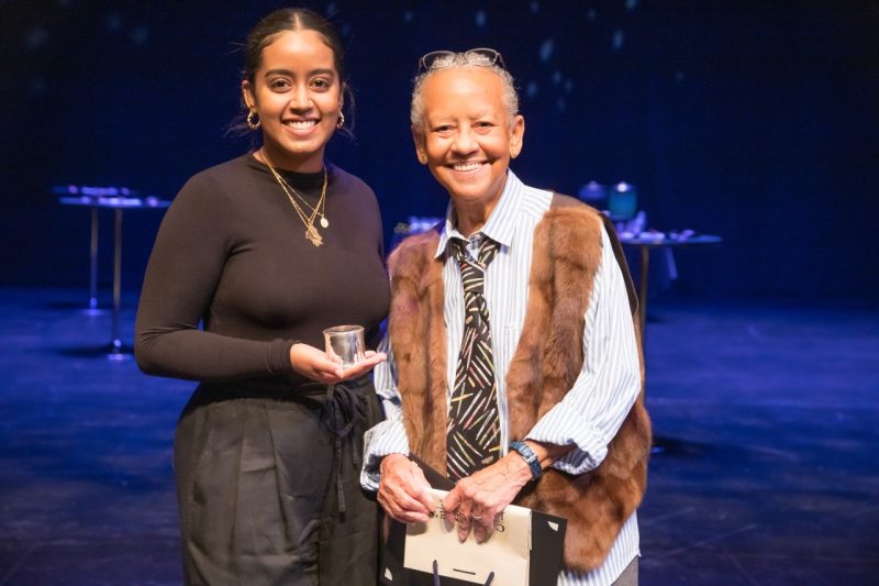 Delina Phicadu, the first-place winner of the 2022 Giovanni-Steger Poetry Prize, joins Nikki Giovanni on stage at the Moss Arts Center following the ceremony.