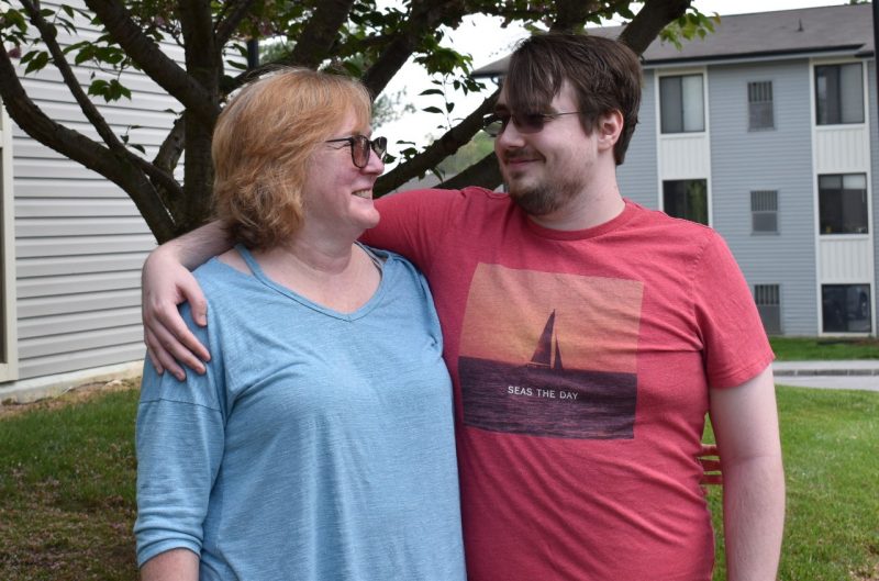 Sharon Stidham and her son James with their arms around each other outside their apartment
