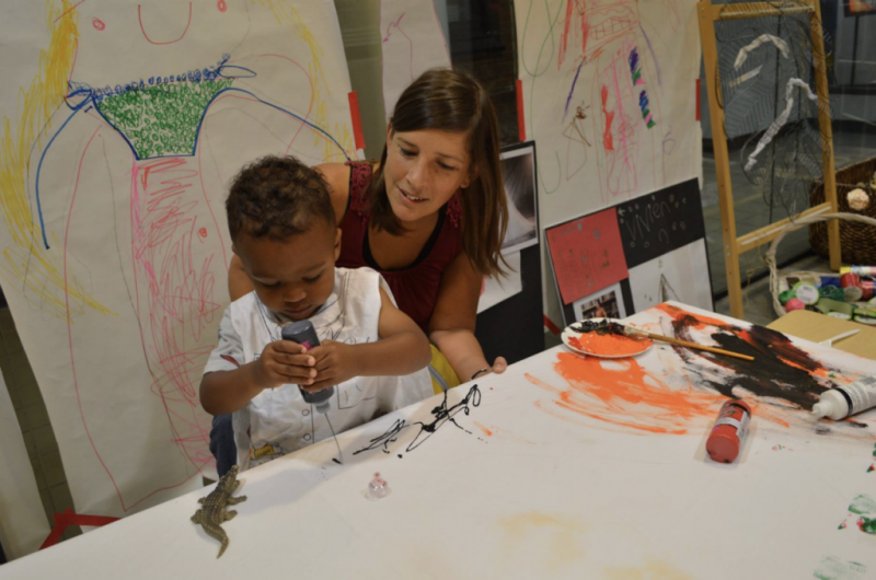 Shannon Marshall Mury helps a child make a craft