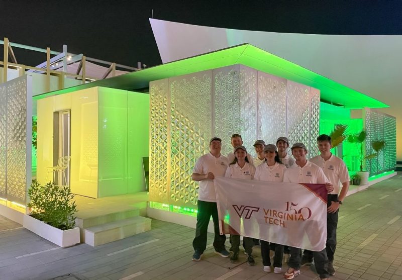 Virginia Tech students pose for a picture in front of FutureHAUS at Expo 2020 Dubai. 