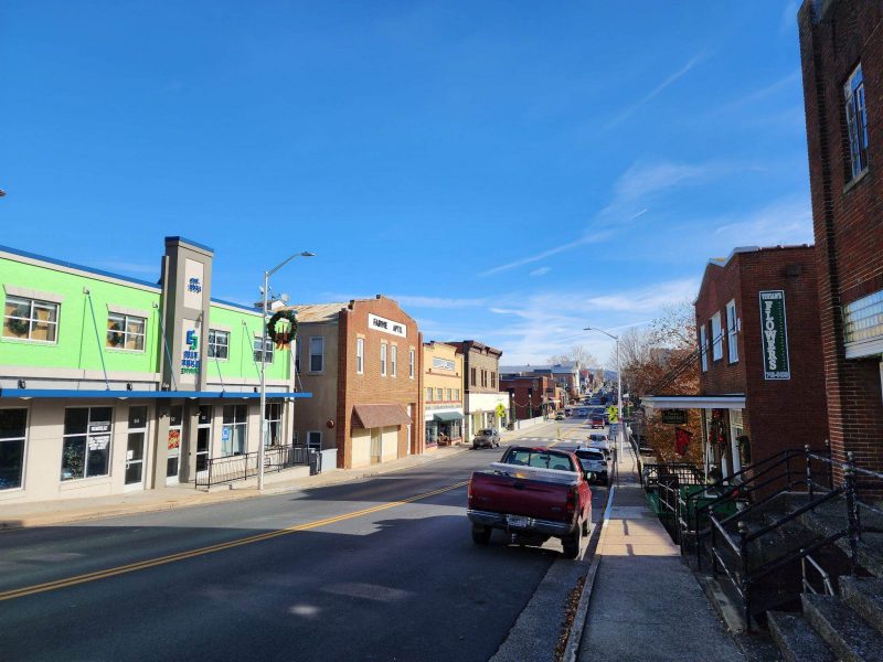 a clear blue sky hovers over the view of a downtown in rural america