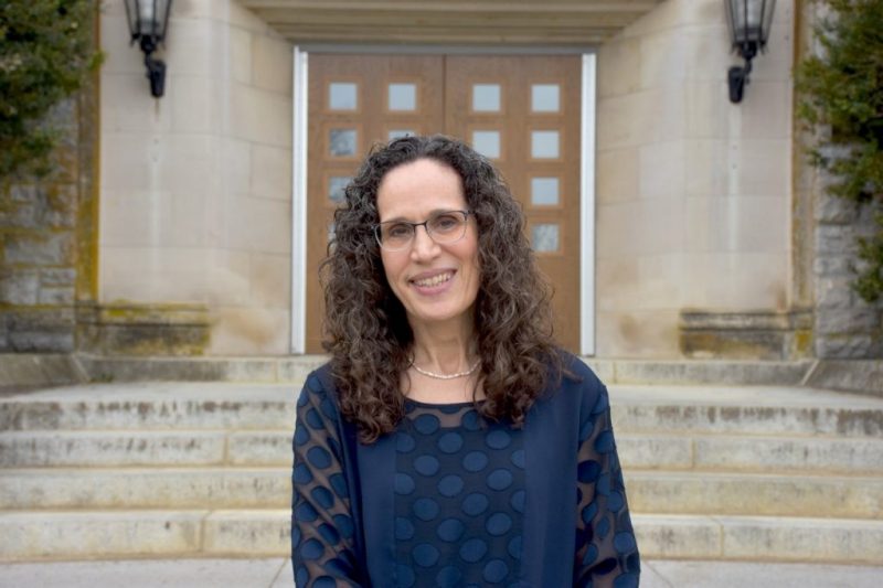 Photo of Angela Scarpa standing in front of a building on VT Campus
