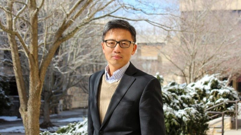 Photo of Yang Zhang standing in front of a tree on VT Campus