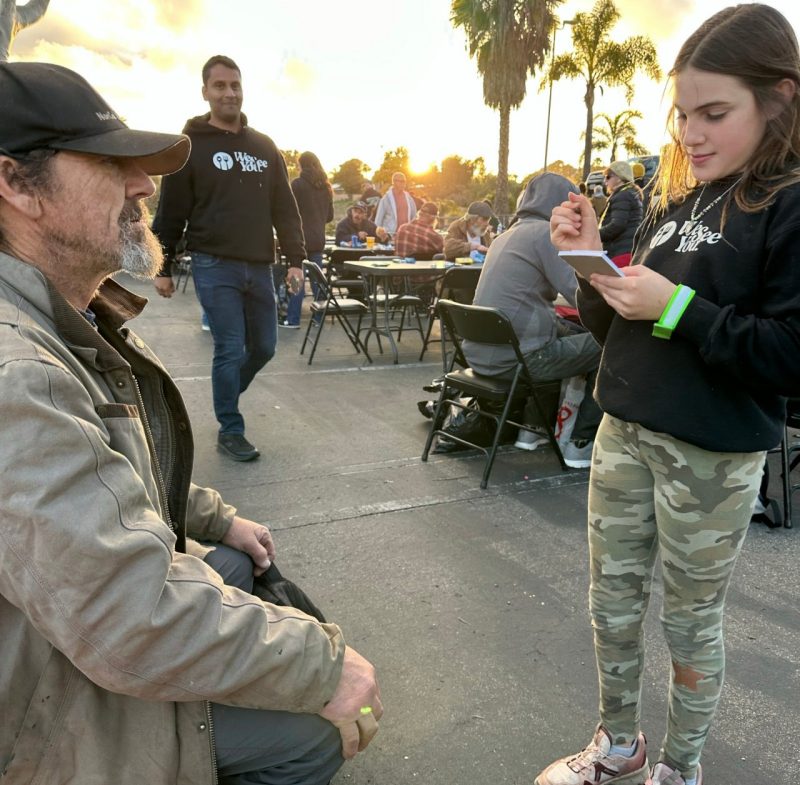 A child helps out at the We See You San Diego Event