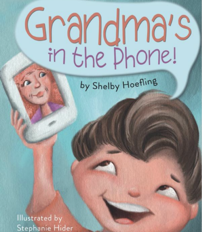 Book cover of Grandma's in the Phone features a child holding a phone with their grandmother's face on it.