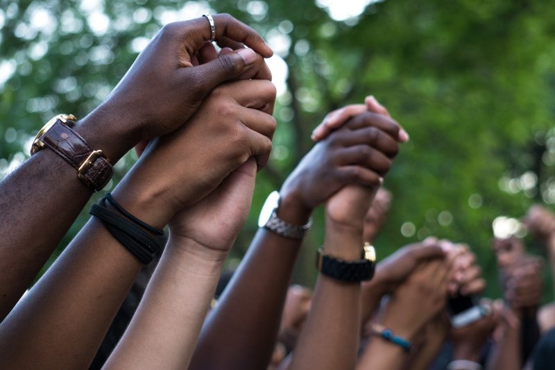 Hands linked together at a Black Lives Matter event in Montreal